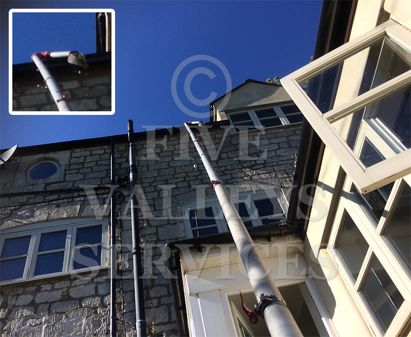 Our pole reaching a third-storey gutter on a stone house, with a close-up of the gutter head