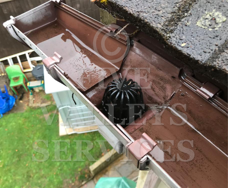The same gutter cleared, with a downpipe guard fitted